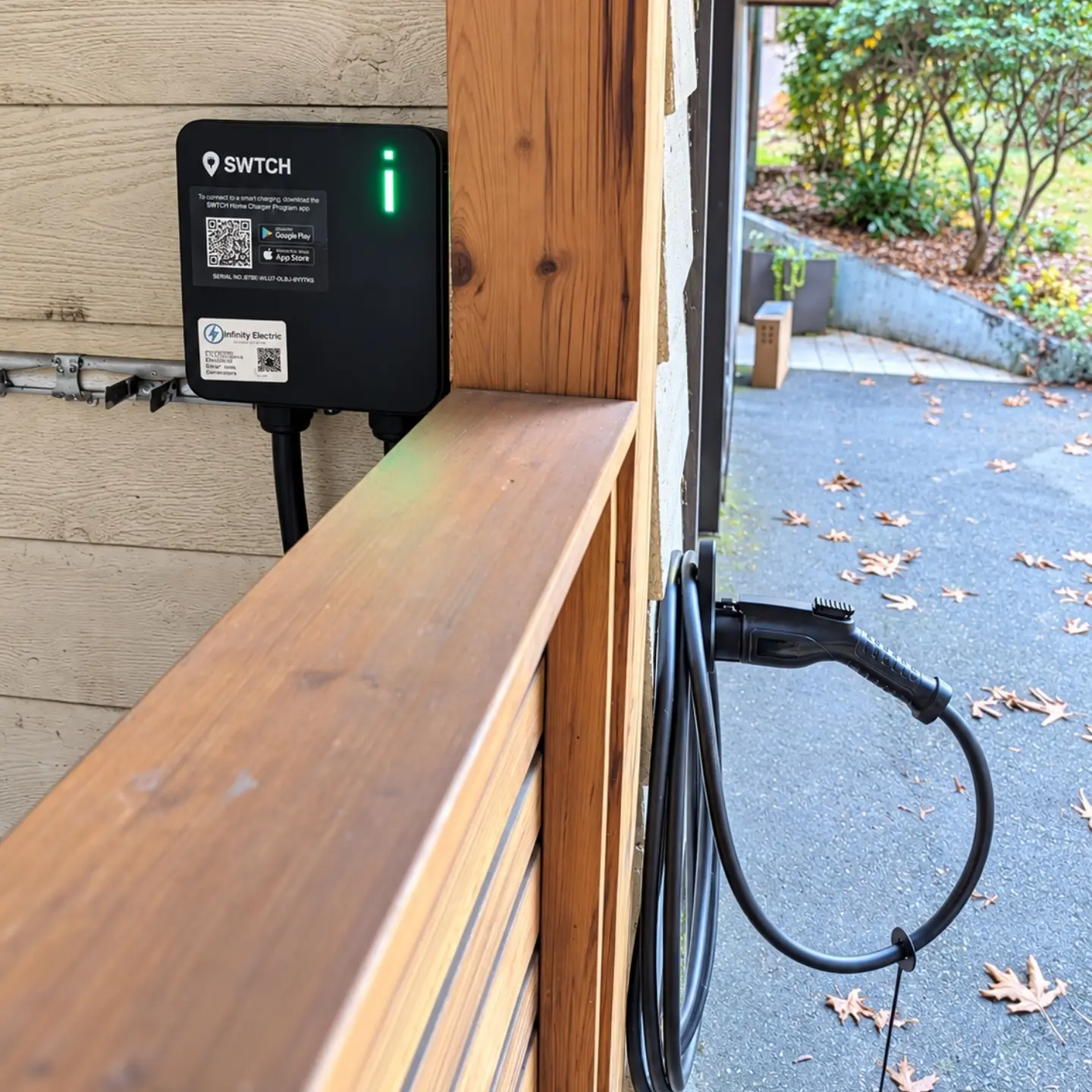 Exterior SWTCH charger with charging cable beside the garage opening